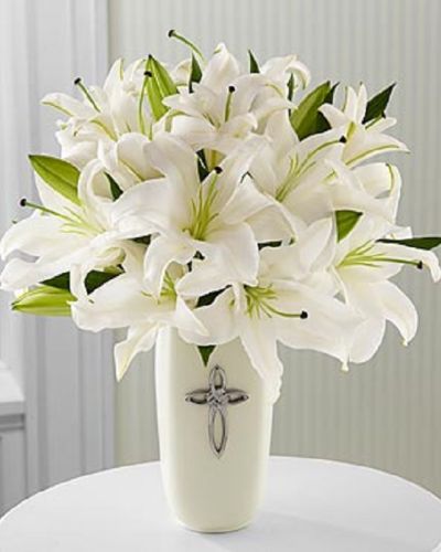 <p>This striking display of pure white lilies will send your heartfelt expressions when words just aren't enough. Arranged in a white ceramic vase and enhanced by a cross, this arrangement is perfect for celebrations, confirmations, sympathy, weddings, or a special anniversary.This is an all-around arrangement.</p>
