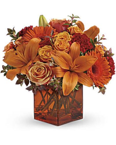 <div id="mark-3" class="m-pdp-tabs-marketing-description">Celebrate the wonder of a new day with warm, golden flowers. A modern orange glass vase is the foundation of this stunning, sun-bright bouquet that energizes any occasion.</div>
<p><del> </del></p>
<p> </p>
<ul>
<li>Orange gerbera daisies, orange roses and red mini carnations are accented with a spray of red huckleberry in an orange cube</li>
</ul>
<div id="desc-3">
<ul>
<li>vase.</li>
</ul>
</div>
<p> </p>
<ul>
<li></li>
</ul>
<p> </p>